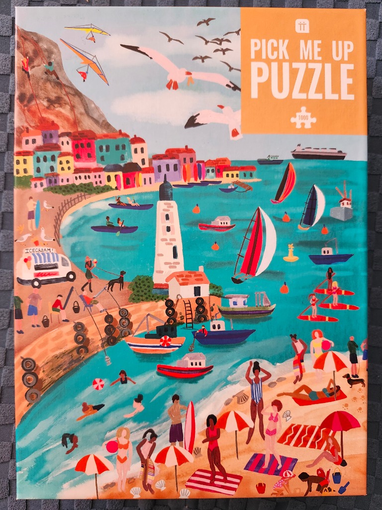 Illustration of a vibrant coastal town with a busy beach, colorful houses, sailboats, and a lighthouse.