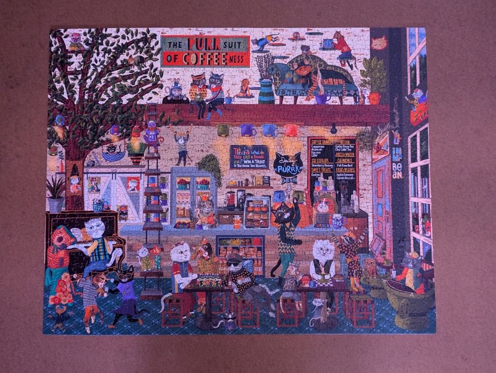 A whimsically illustrated two-story cat-themed coffee shop called The Purr-suit of Coffeeness.