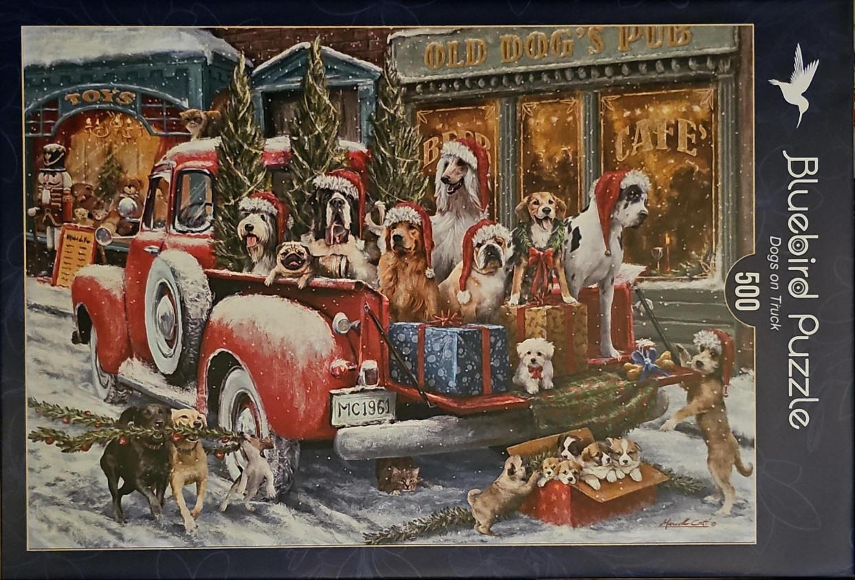 An illustration of many different dog breeds wearing Santa hats riding in the back of a red vintage pickup truck.