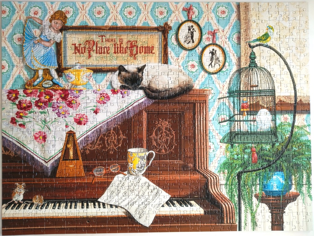 A cozy vintage interior scene featuring an upright piano, a sleeping Siamese cat, and various antique decorative items.