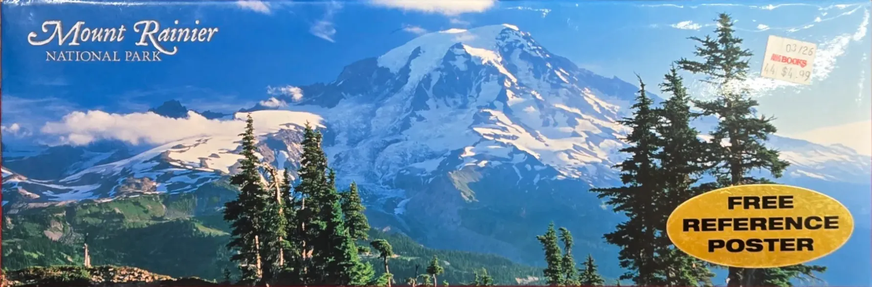 A panoramic landscape photograph of Mount Rainier in Washington state featuring snow-capped peaks and evergreen trees.