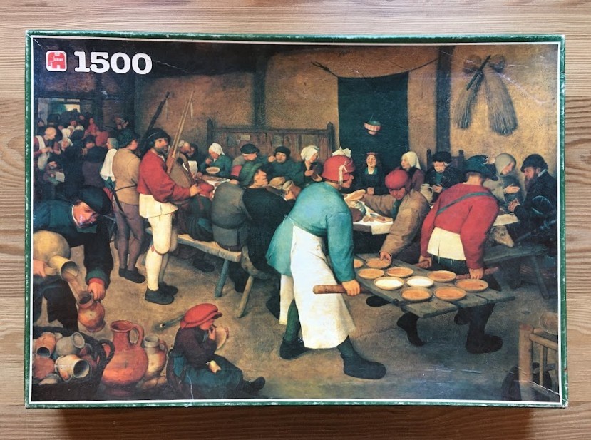 A Renaissance-style oil painting depicting a crowded, rustic peasant feast in a dimly lit tavern or barn.