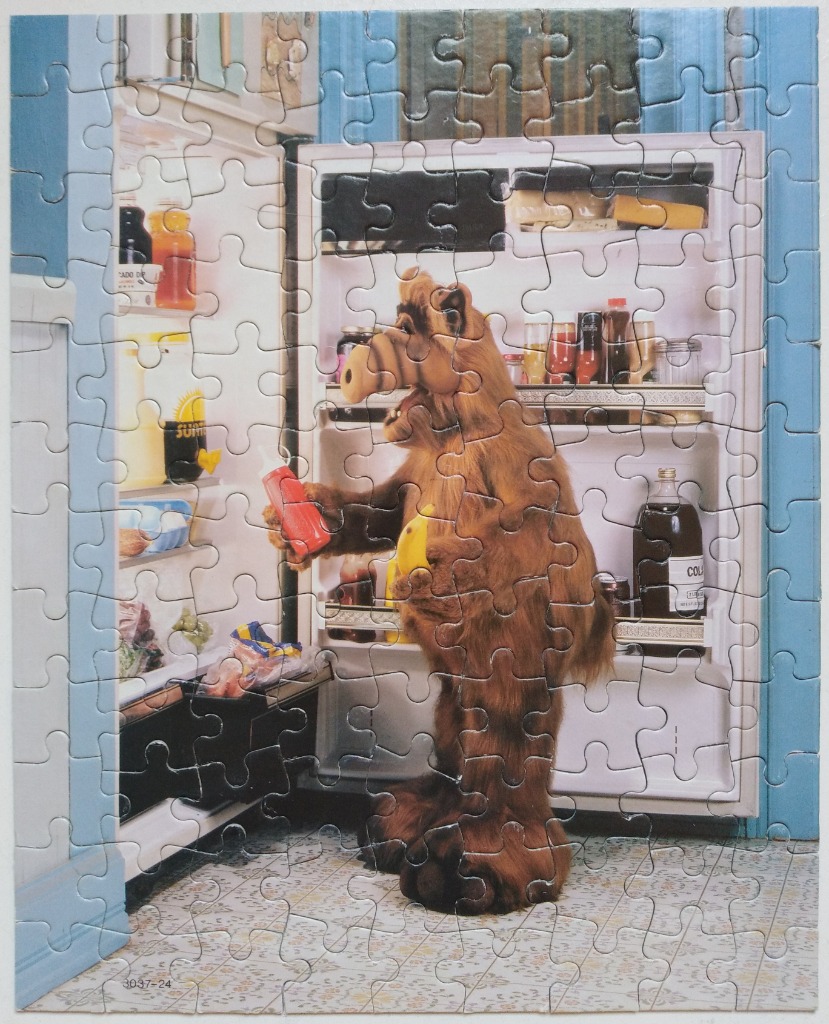 ALF standing in front of an open refrigerator