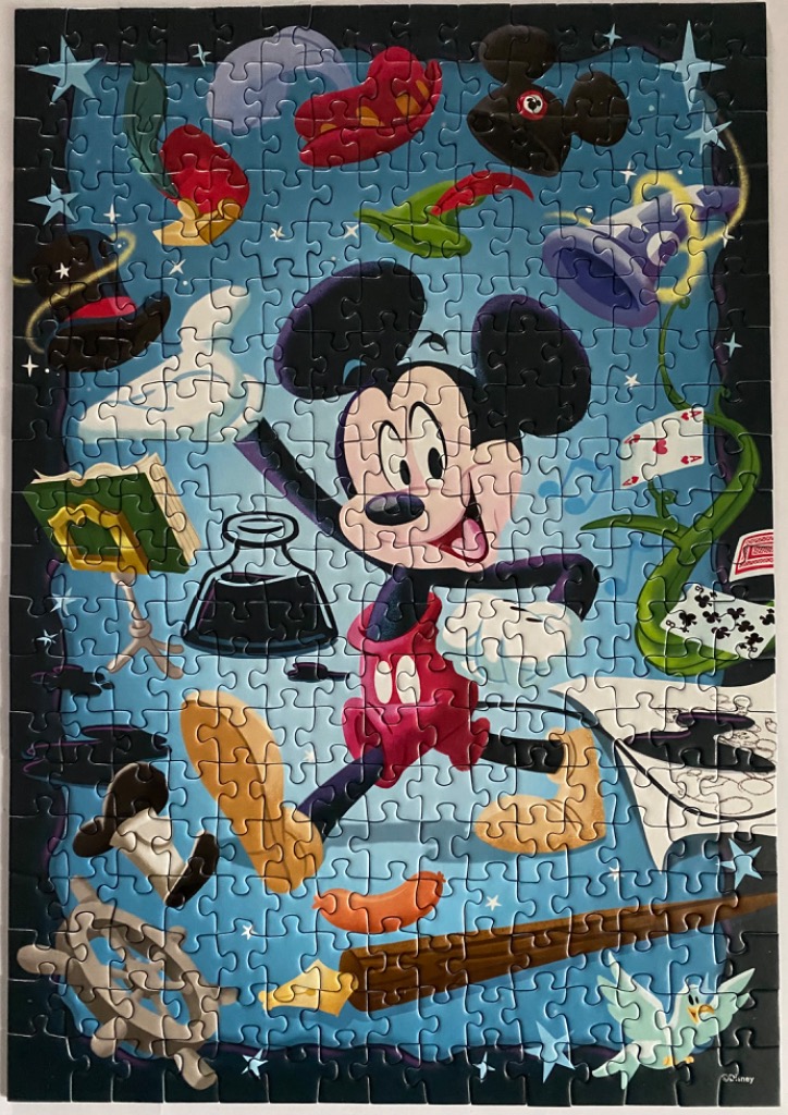 Mickey Mouse in a magical wizard-themed illustration with floating objects.