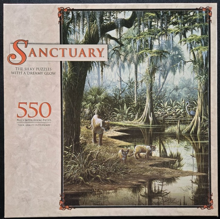 A mother panther and her two kittens walking along a swampy, moss-draped forest waterway.