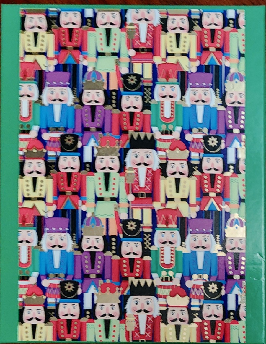 A repeating pattern of colorful nutcracker figures in various uniforms.