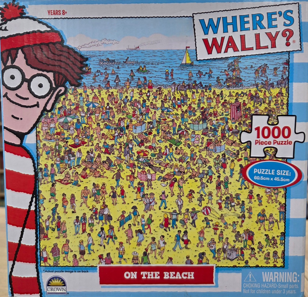 A crowded beach scene in a classic cartoon illustration style featuring Wally's head in the foreground.