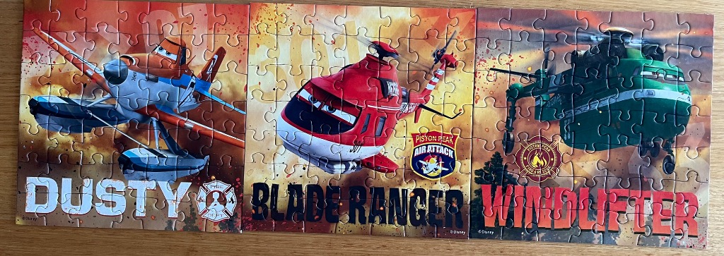 A three-panel illustration of Dusty, Blade Ranger, and Windlifter from Planes: Fire & Rescue against a fiery backdrop.