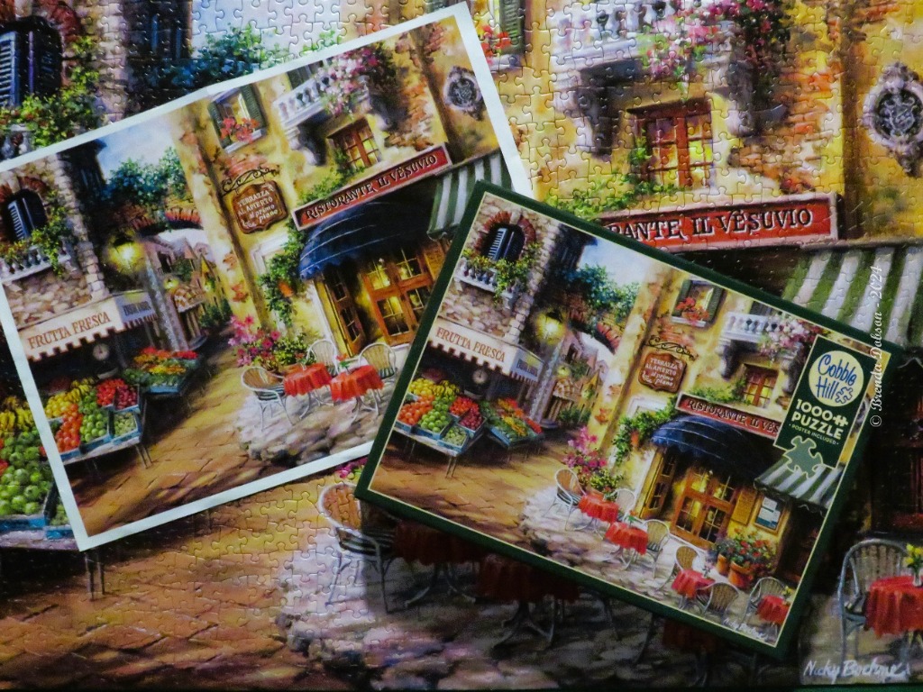 A charming Italian street scene with a fruit stand and outdoor restaurant tables at dusk.