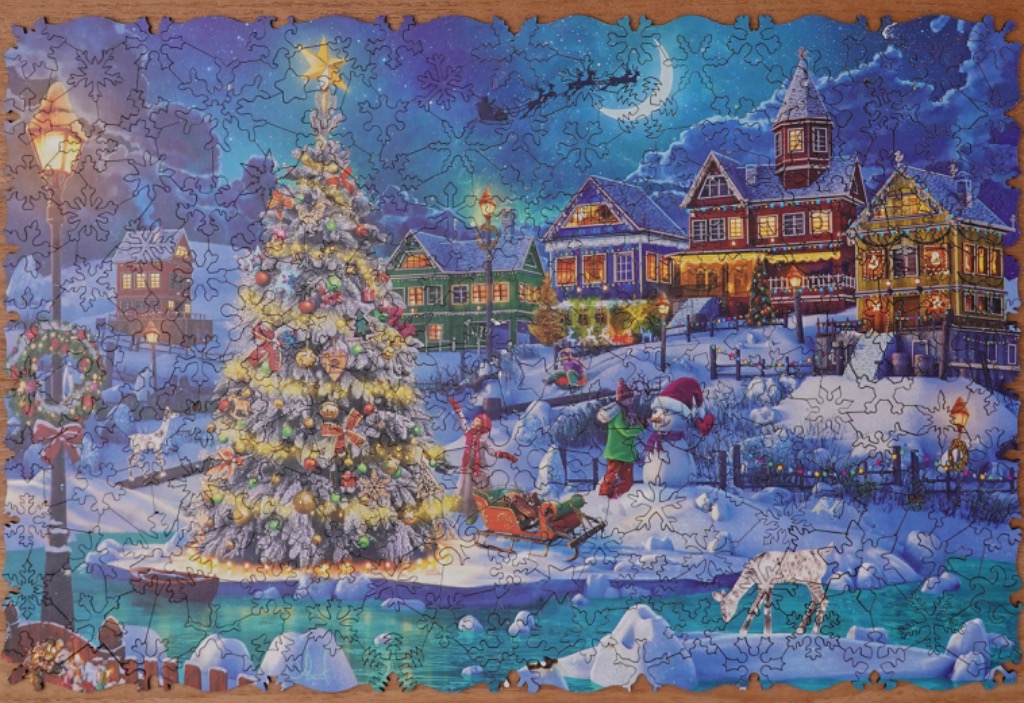 A whimsical nighttime winter scene featuring a large decorated Christmas tree, cozy houses, and figures in the snow.