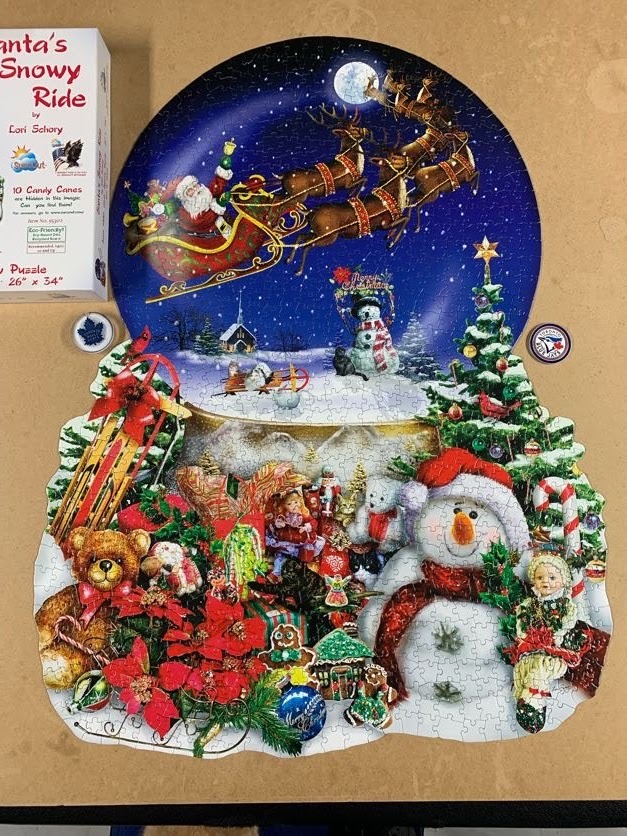 A whimsical Christmas-themed illustration shaped like a snow globe featuring Santa and a snowman.