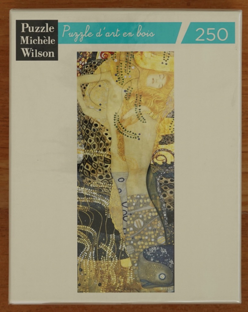 A vertical fine art reproduction of Gustav Klimt's Danae, featuring a woman curled in a golden, ornate composition.