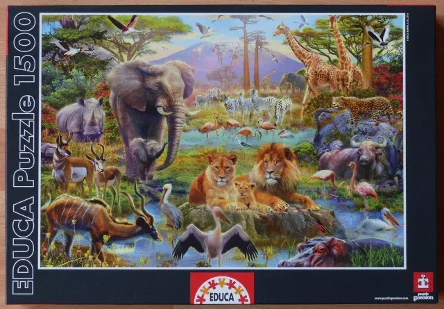 A lush African savanna scene featuring a diverse gathering of wild animals near a waterhole at sunset.