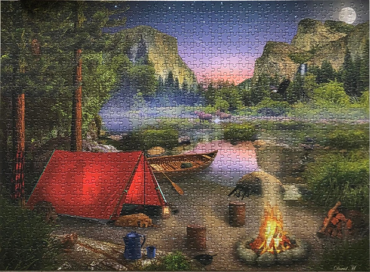 A red tent, a campfire, and a rowboat by a calm lake at twilight in a mountainous wilderness setting.