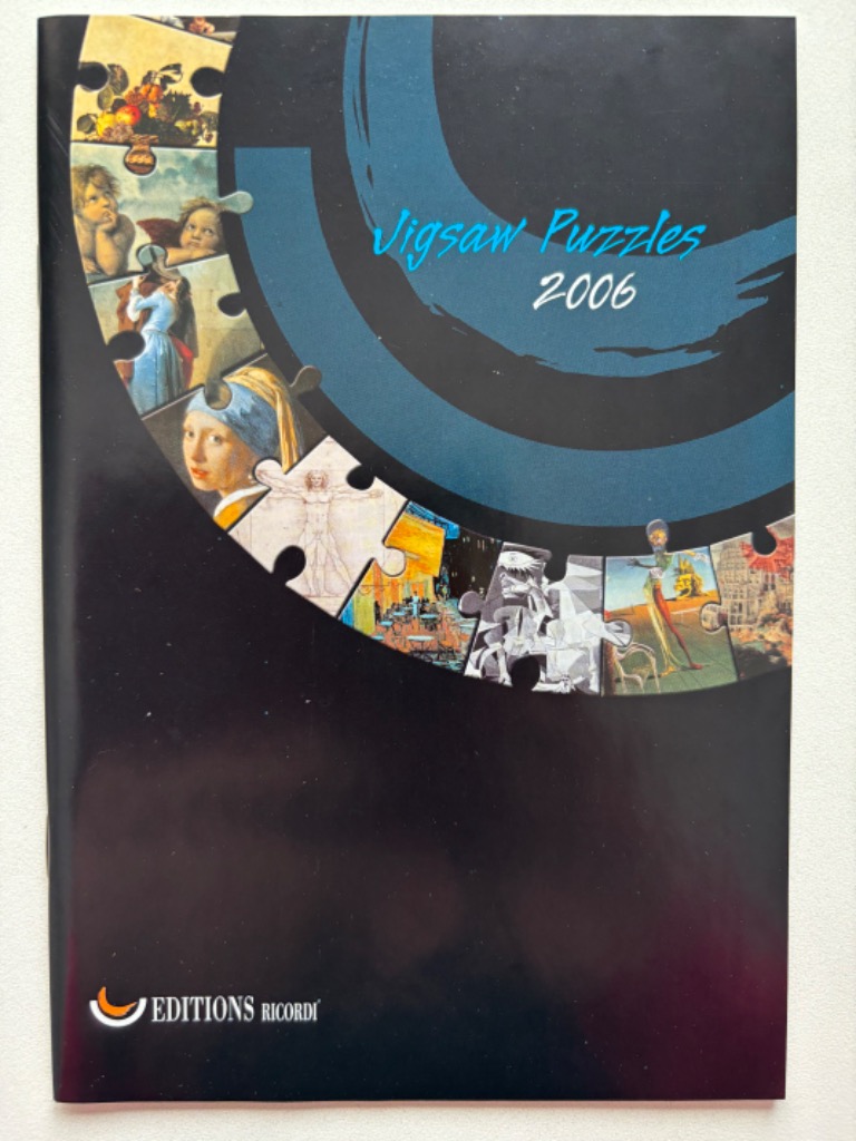 A black cover featuring an arc of famous art masterpieces arranged like puzzle pieces against a dark blue circular motif.
