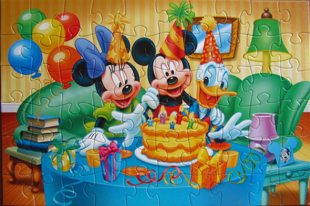 Minnie Mouse, Mickey Mouse, and Donald Duck celebrating with a birthday cake.