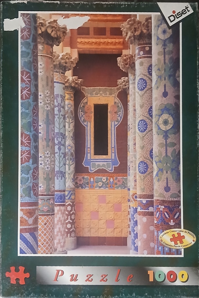 Interior view of columns decorated with colorful floral mosaic tiles, reminiscent of Modernisme architecture.