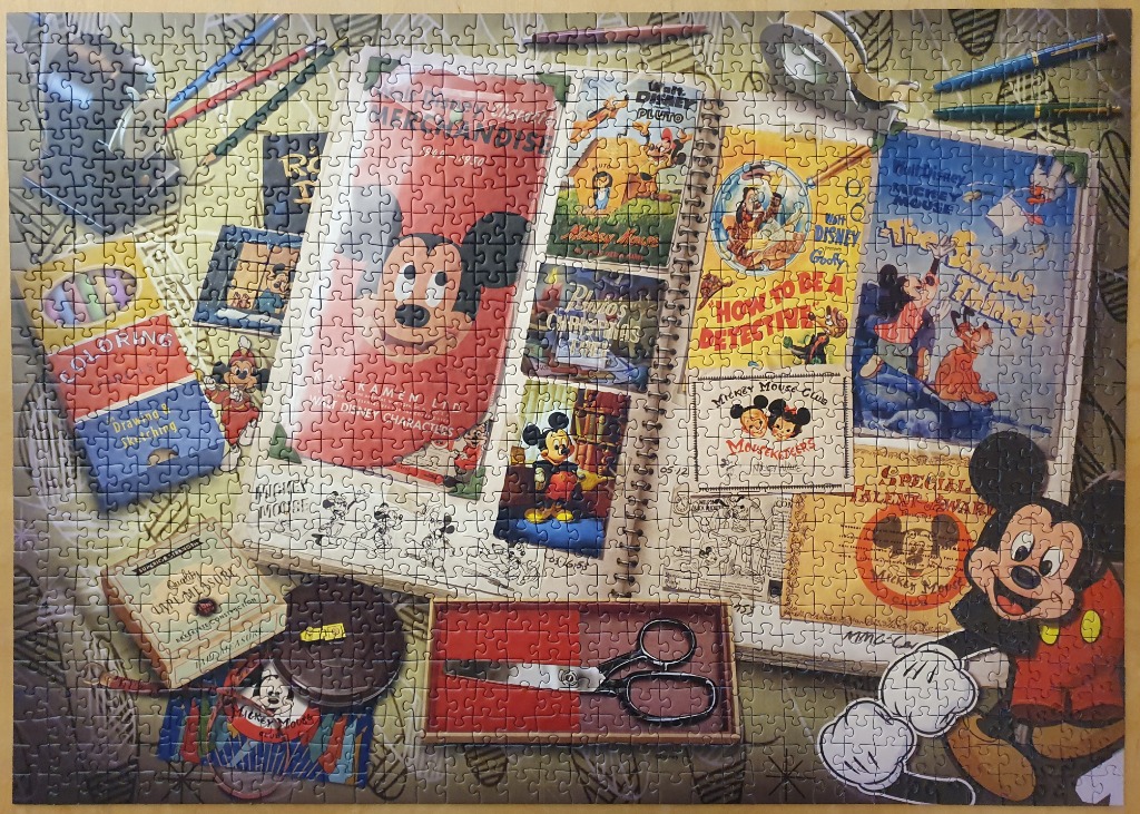 A nostalgic collage of vintage Mickey Mouse memorabilia and stationery items arranged on a desk.