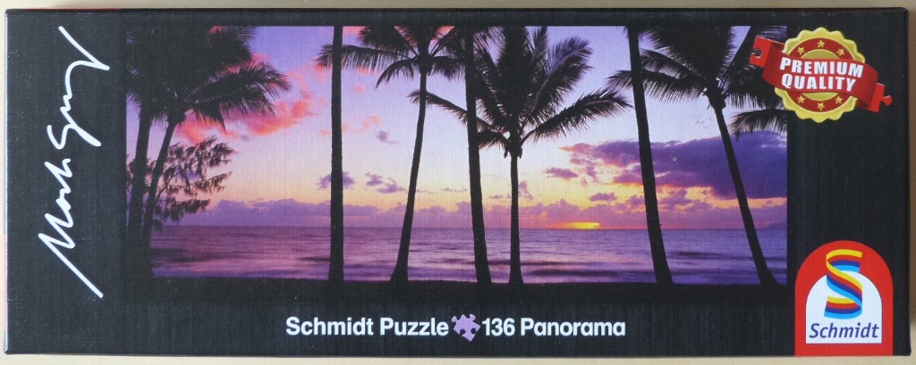 A panoramic photograph of silhouetted palm trees against a vibrant purple and orange sunset over the ocean.