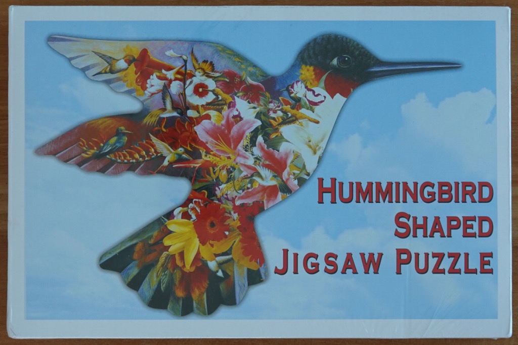 A double-exposure illustration of a hummingbird filled with smaller hummingbirds and vibrant flowers against a blue sky.