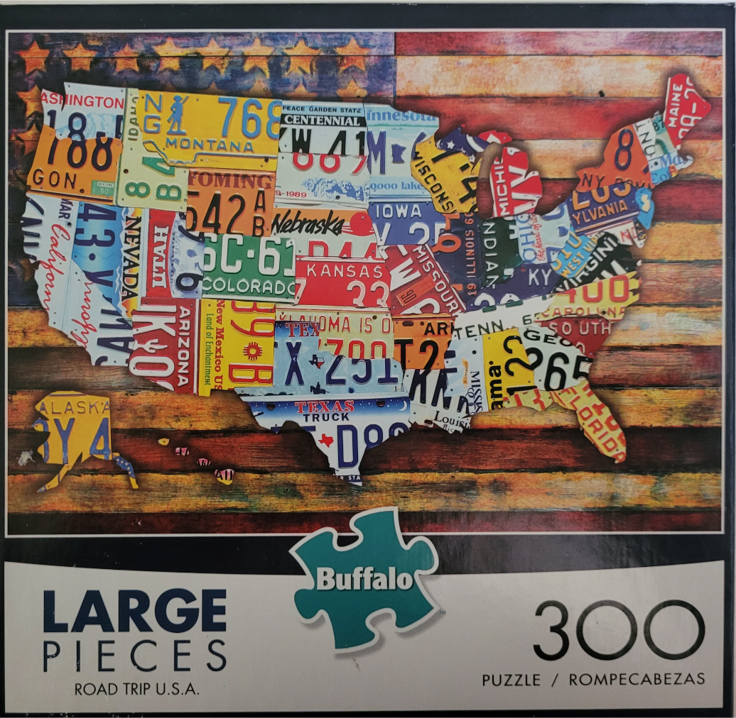 A collage of vintage US license plates shaped into a map of the United States against a wooden American flag background.