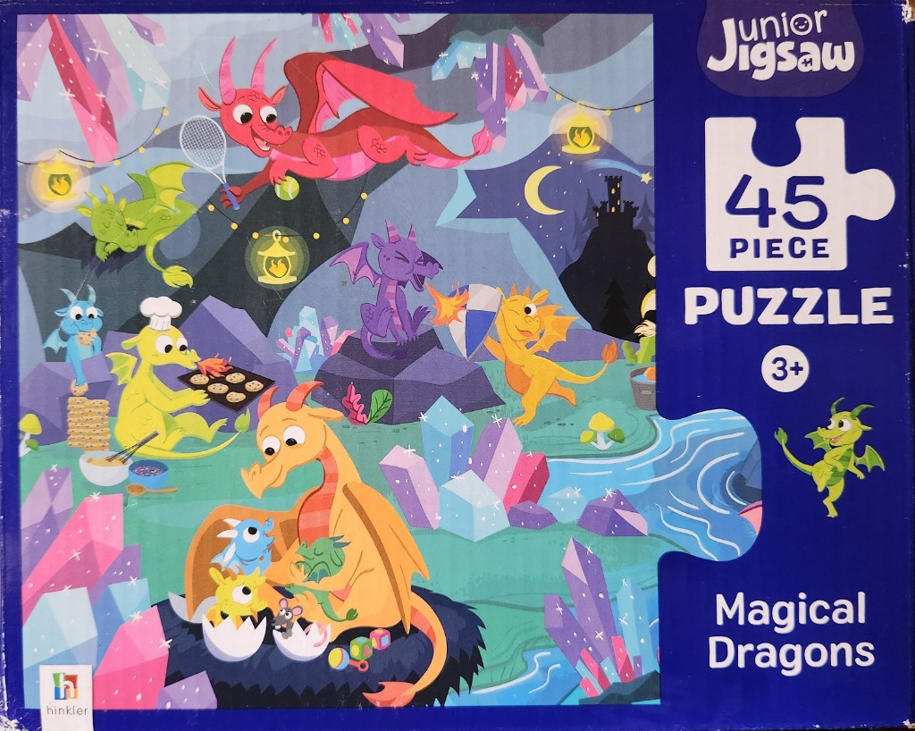 Cartoon illustration of colorful dragons playing in a magical crystal cavern.