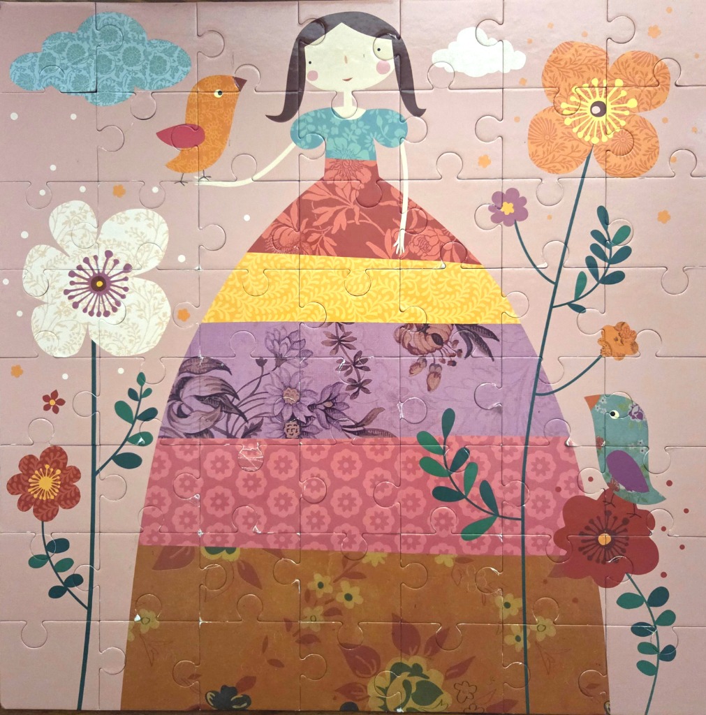 A whimsical illustration of a girl in a multi-patterned dress surrounded by stylized flowers and birds.