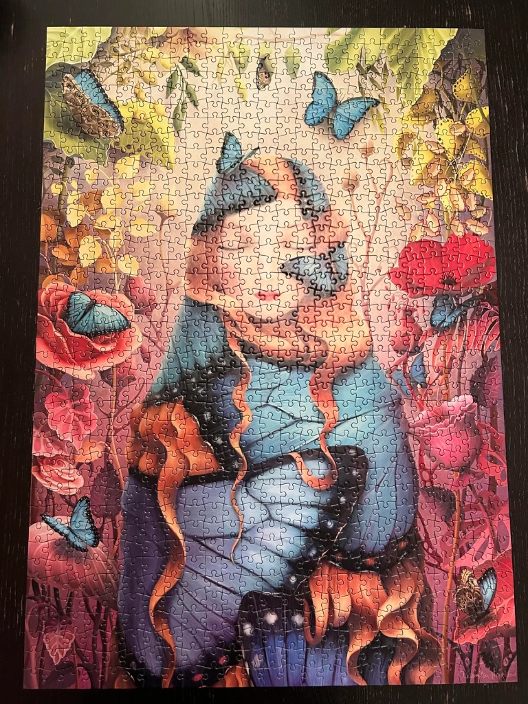 An ethereal illustration of a figure with orange hair and blue butterfly wings in a dreamlike garden.