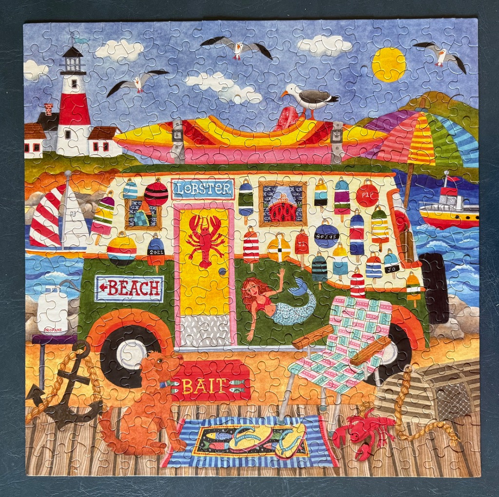 A whimsical seaside scene featuring a decorated camper van, a mermaid, and coastal decor.