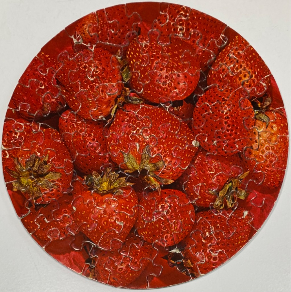 A circular collection of ripe, red strawberries.