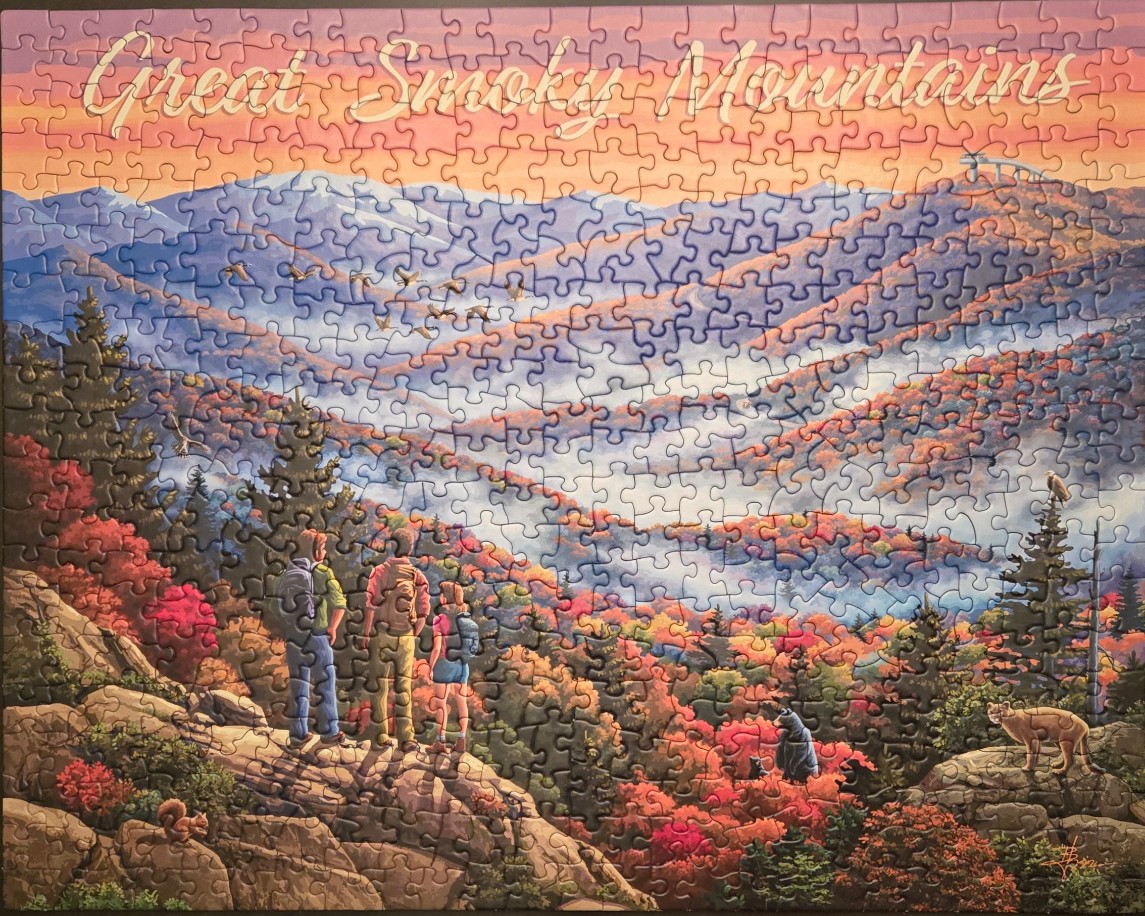 An illustration of three hikers overlooking a misty, autumn-colored Great Smoky Mountains landscape at sunset.