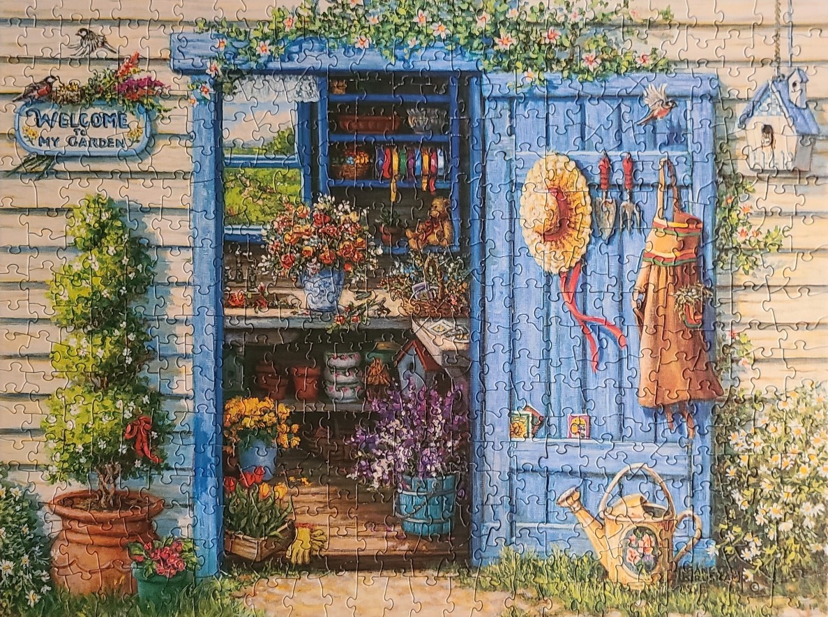 A cozy garden shed with blue doors, filled with flowers, tools, and a sun hat, surrounded by greenery.