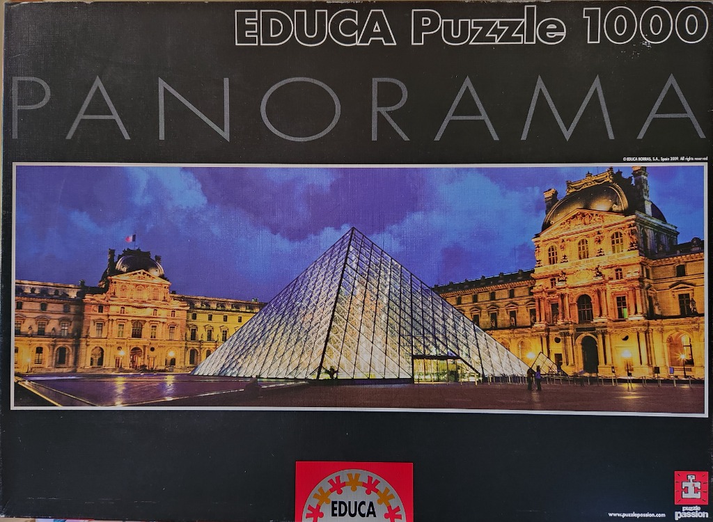 The Louvre Pyramid in Paris illuminated at twilight