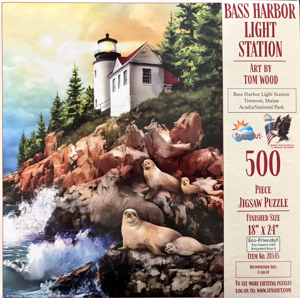 Painting of Bass Harbor Light Station with seals on the rocky shoreline at sunset.