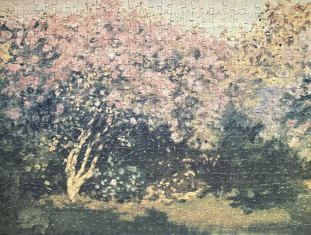 Impressionist painting of a tree in bloom with a soft, hazy light and a muted colour palette.