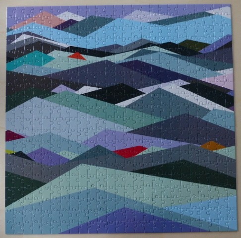 Abstract geometric mountain landscape with layered hills in shades of blue, purple, teal, and occasional red accents.