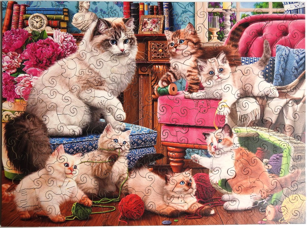 A detailed illustration of a mother cat and several kittens playing in a cozy, Victorian-style room.
