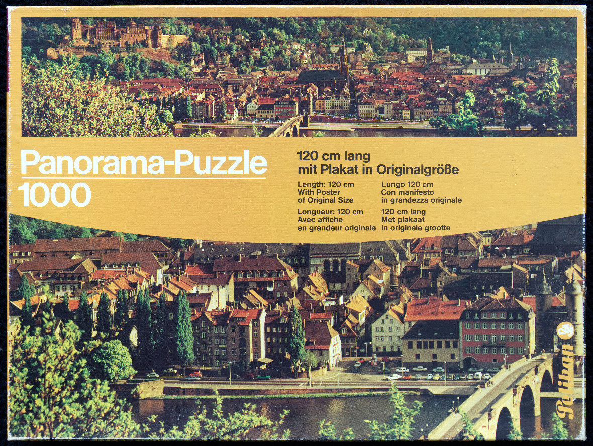 A panoramic aerial view of Heidelberg, Germany, featuring its castle, Old Town, and the Neckar River.