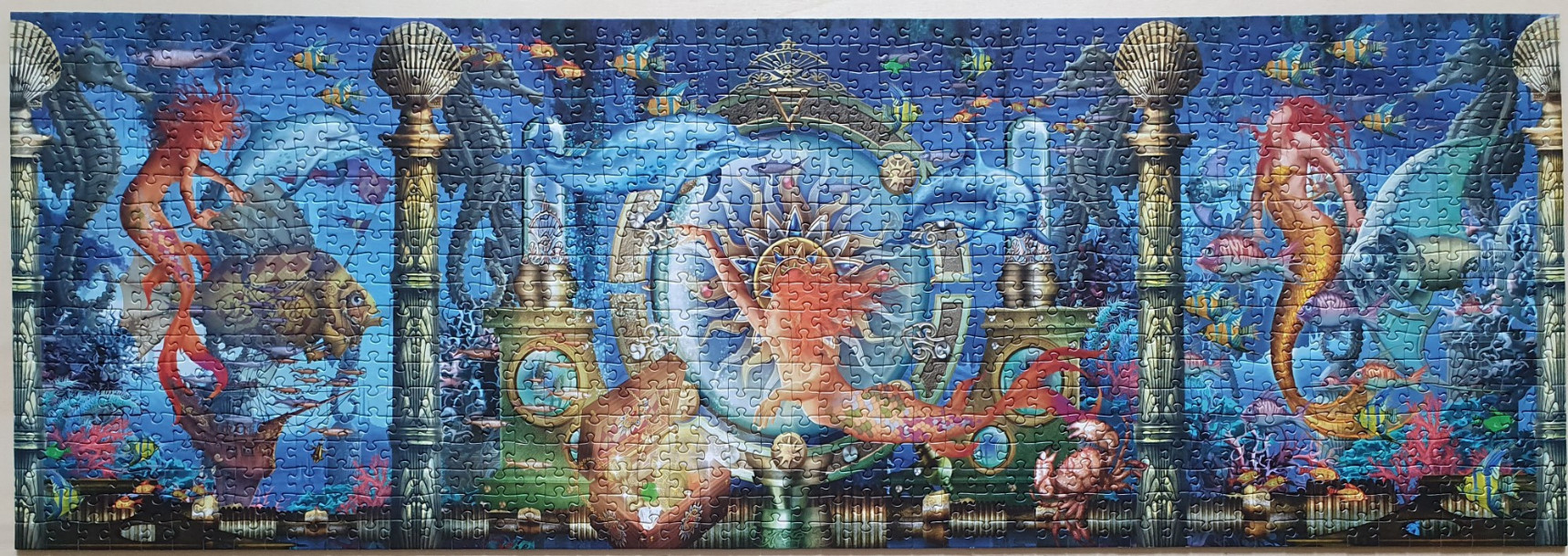 A fantasy illustration of mermaids in a deep blue underwater palace setting.