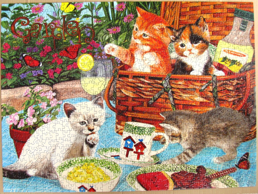 Four kittens playing in a sunny garden setting with a picnic basket and lemonade.