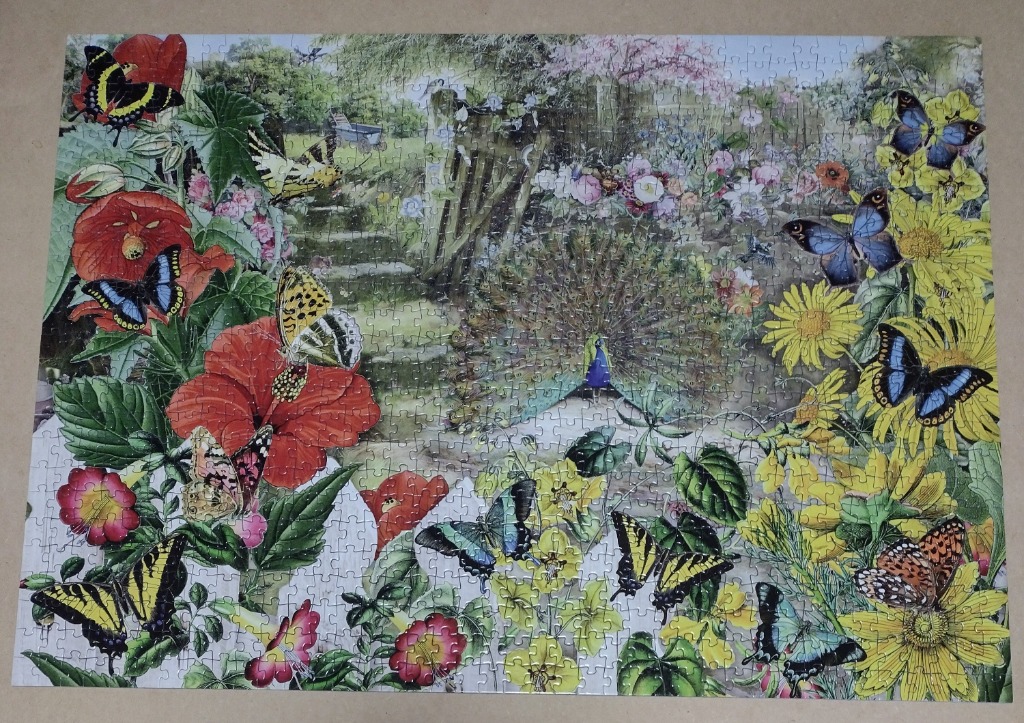 A lush garden scene filled with vibrant flowers, diverse butterflies, and a peacock displaying its tail feathers.