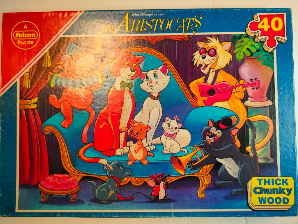 The Aristocats cartoon characters playing music in a brightly colored living room scene.