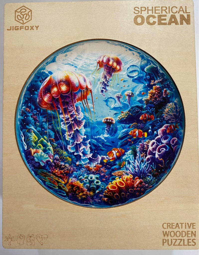 A vibrant circular illustration of a coral reef underwater featuring glowing jellyfish and clownfish.