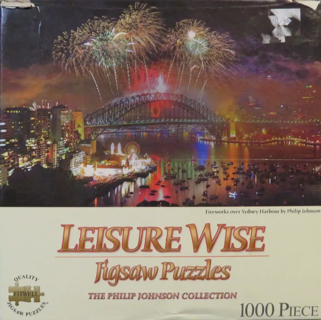 Fireworks display over the Sydney Harbour Bridge at night with city lights reflected in the water.