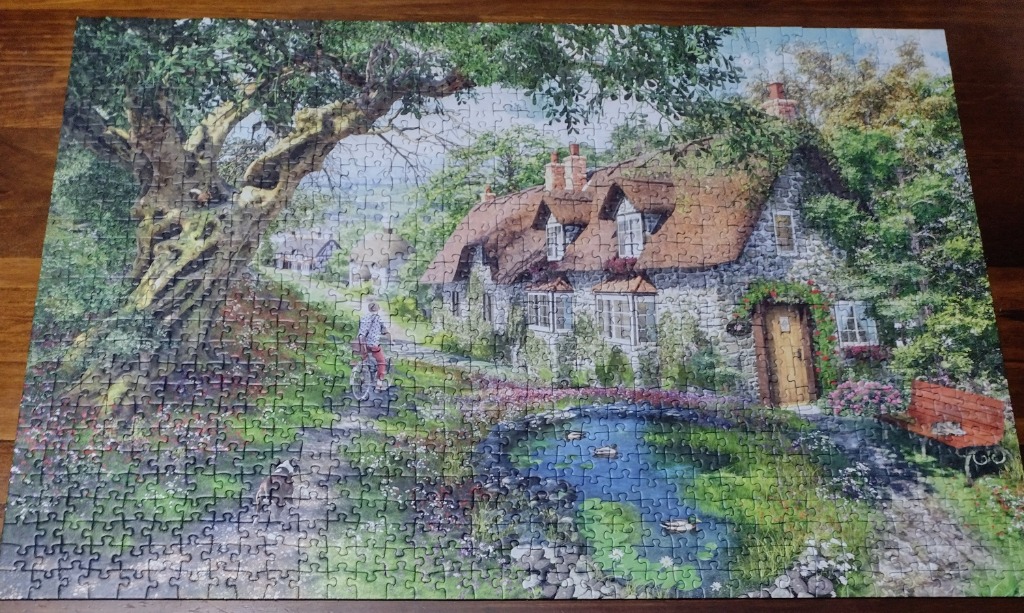 A peaceful English cottage landscape with a cyclist, a pond, and a large oak tree in a painterly style.