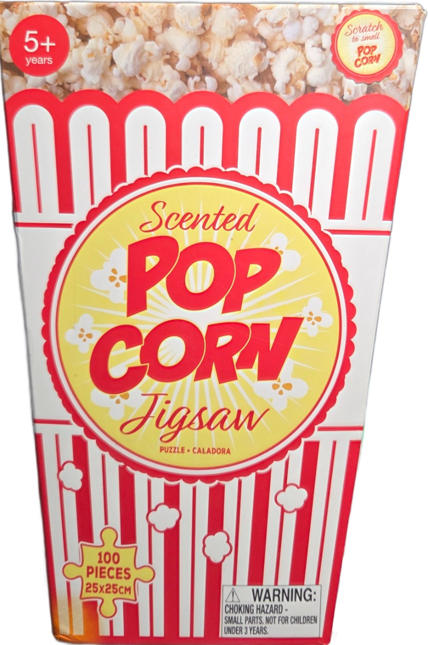 A bucket of popcorn featuring red and white vertical stripes, a circular label, and a pile of popcorn on top.