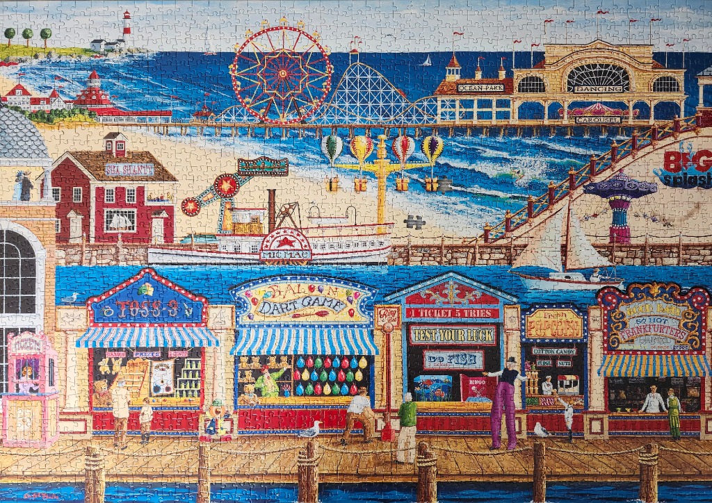 A vibrant illustration of a bustling seaside boardwalk amusement park with game stalls and a Ferris wheel.