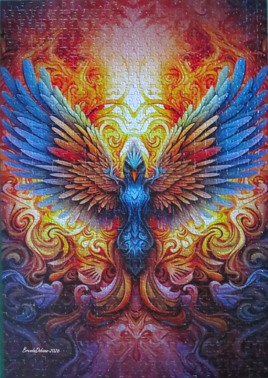 A digital illustration of a stylized blue phoenix rising from intricate, swirling flames of red, orange, and gold.