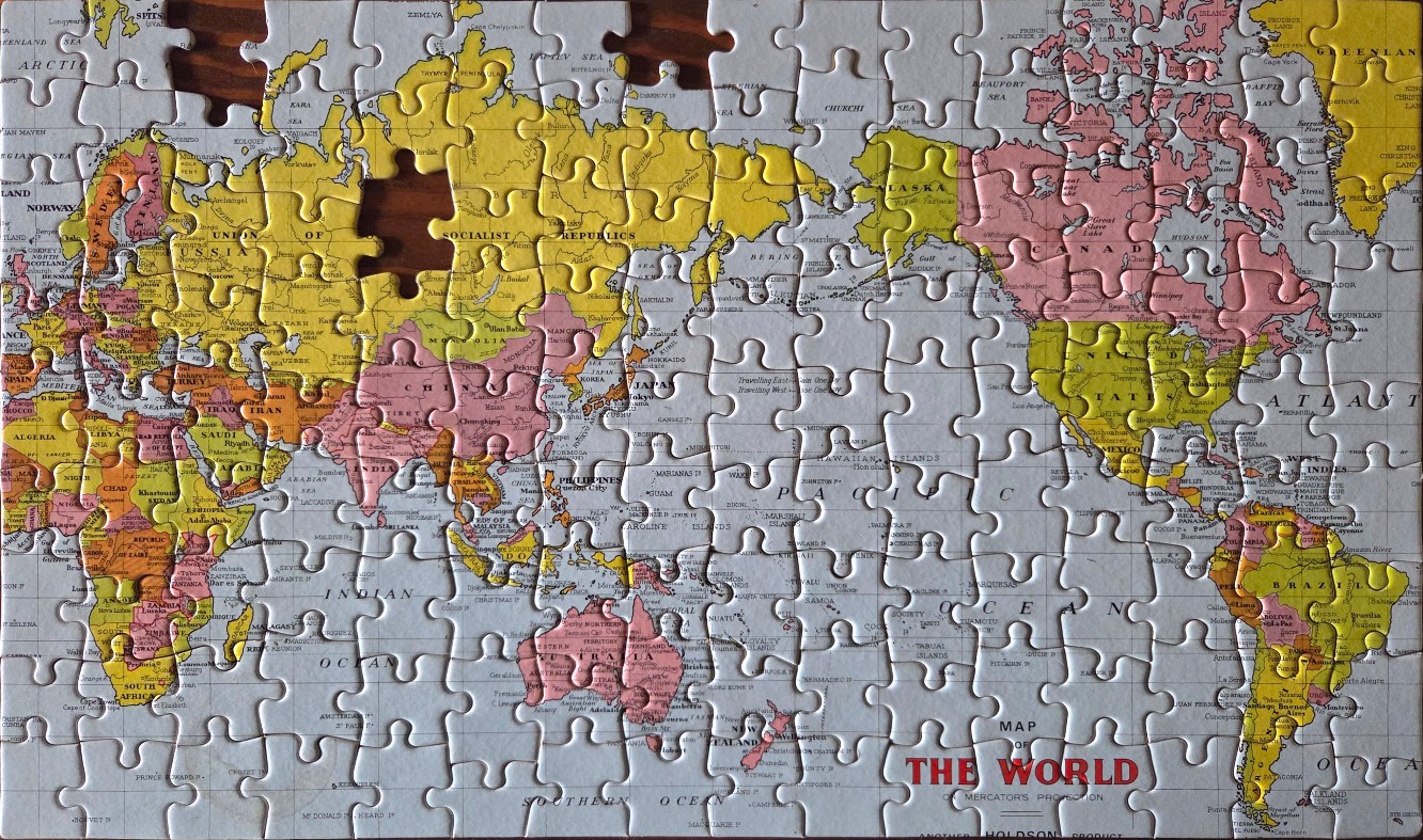 Vintage-style world map in yellow, pink, and orange tones with Mercator projection.