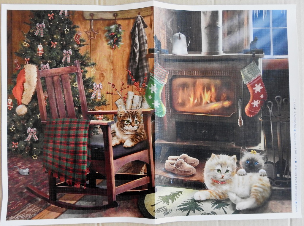 Three kittens in a cozy, festive room with a Christmas tree and a wood-burning stove.
